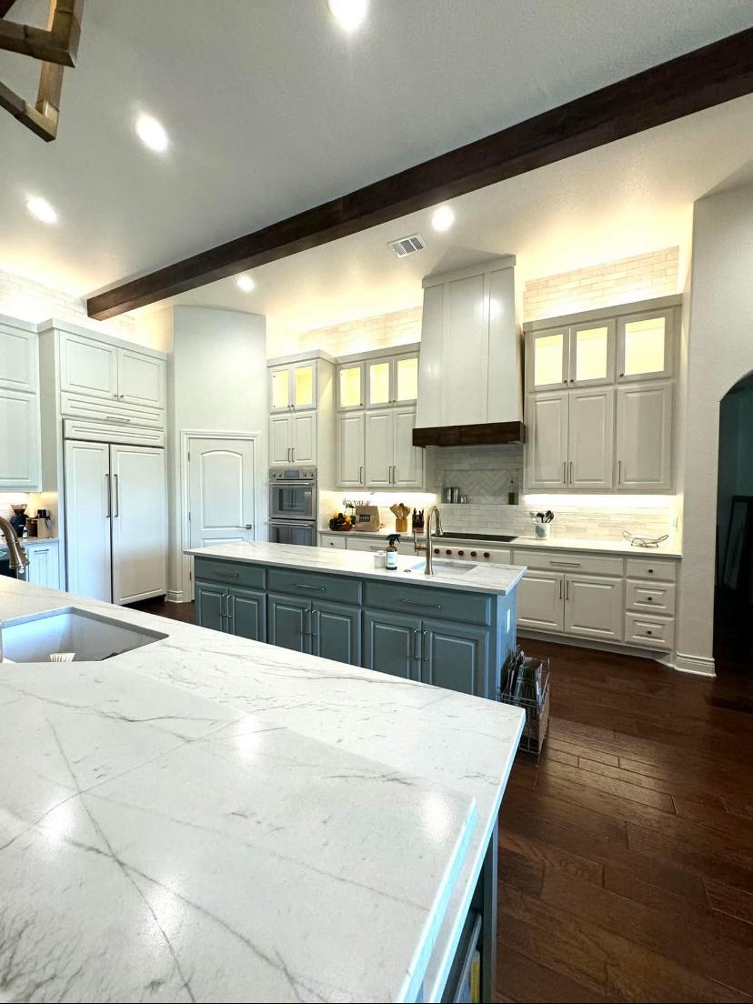 Luxury kitchen renovation with marble countertops, custom cabinetry and wood beam ceiling